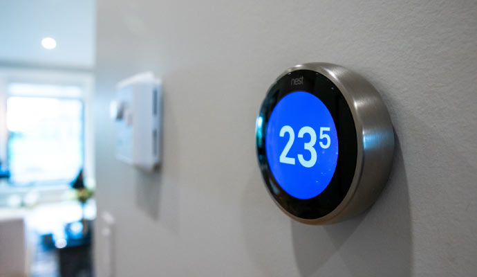 A smart thermostat installed and mounted on a wall