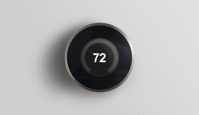 A smart thermostat installed and mounted on a wall