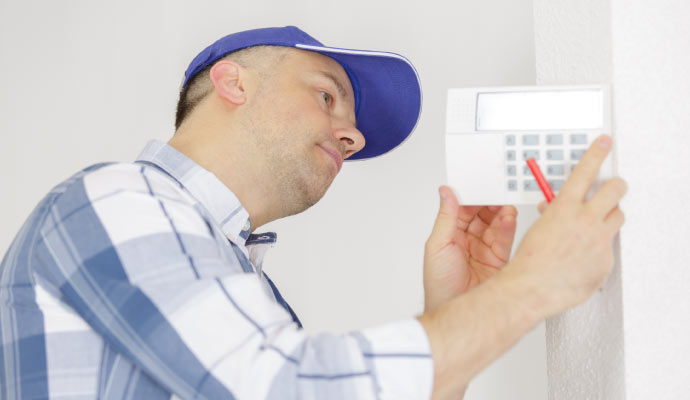 Person installing smart thermostat with equipment