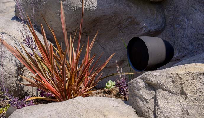 Landscaped area with an installed speaker