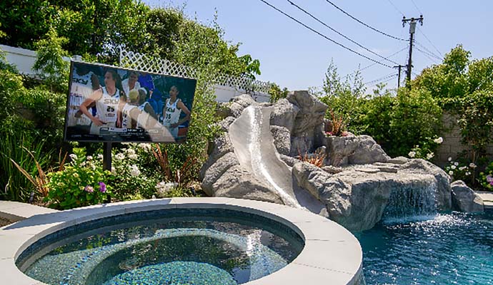 Weatherproof tv installed on the side of a pool