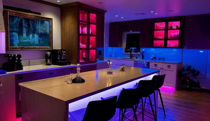 a modern kitchen area with ambient lighting