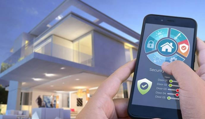  a hand holding a smartphone with a home automation app to manage various home features remotly