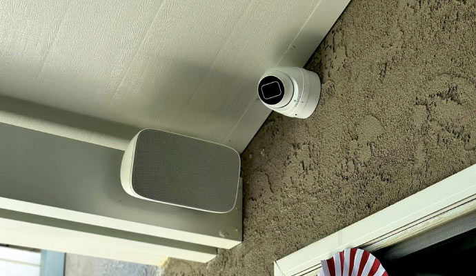 a surveillance camera mounted on a wall neer ceiling